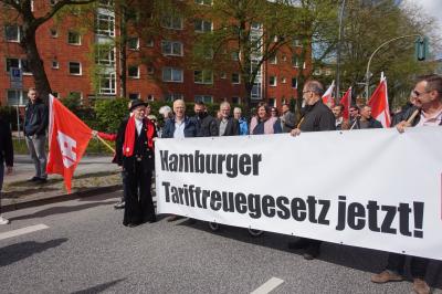 IG BAU-Gewerkschafter mit Transparent "Hamburger Tariftreuegesetzt jetzt" neben Bürgermeister Peter Tschentscher